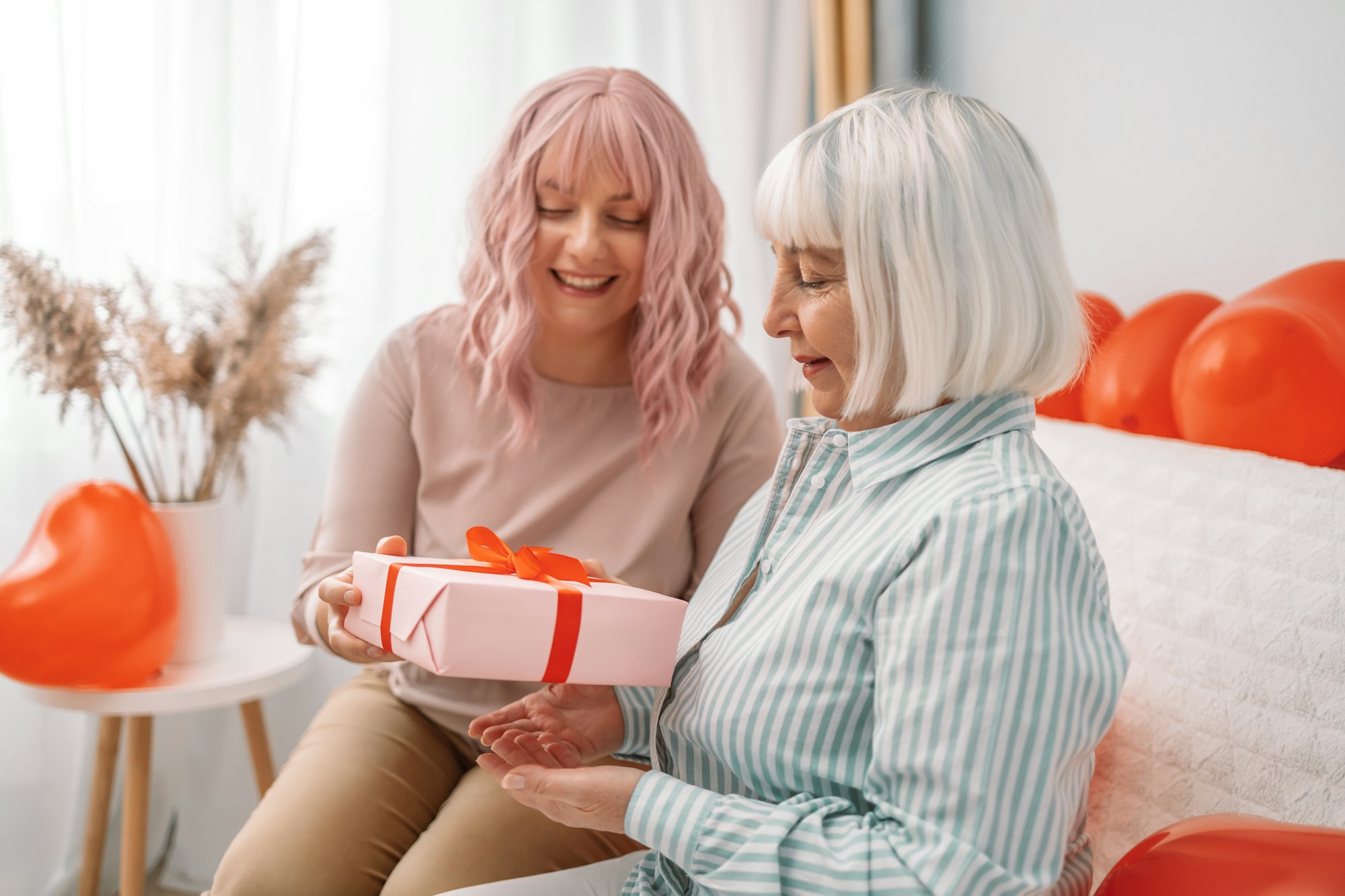 daughter gives her mom a gift. International Women Day