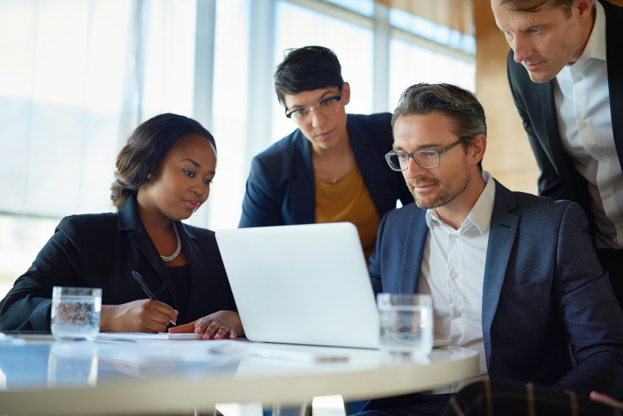 Its a new venture in the making. Shot of four corporate businesspeople working in the boardroom.