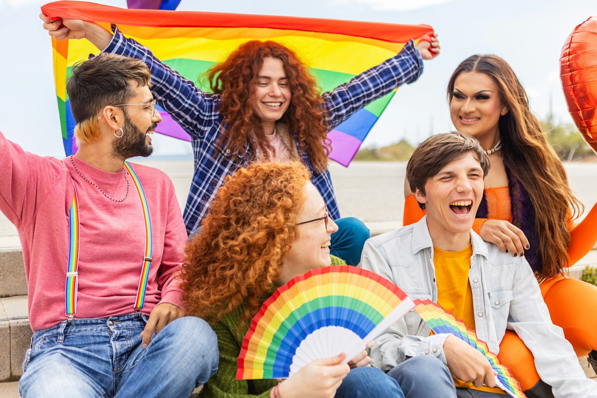 LGBT community people celebrating gay pride month together outdoors.