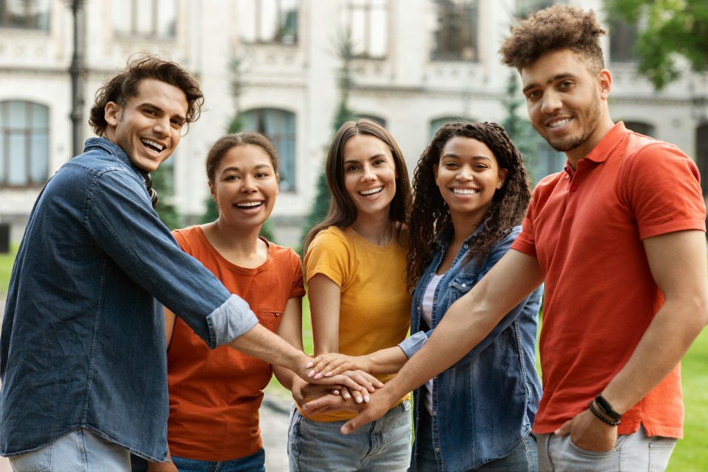 Students Community. Group Of Happy College Friends Joining Hands Together Outdoors