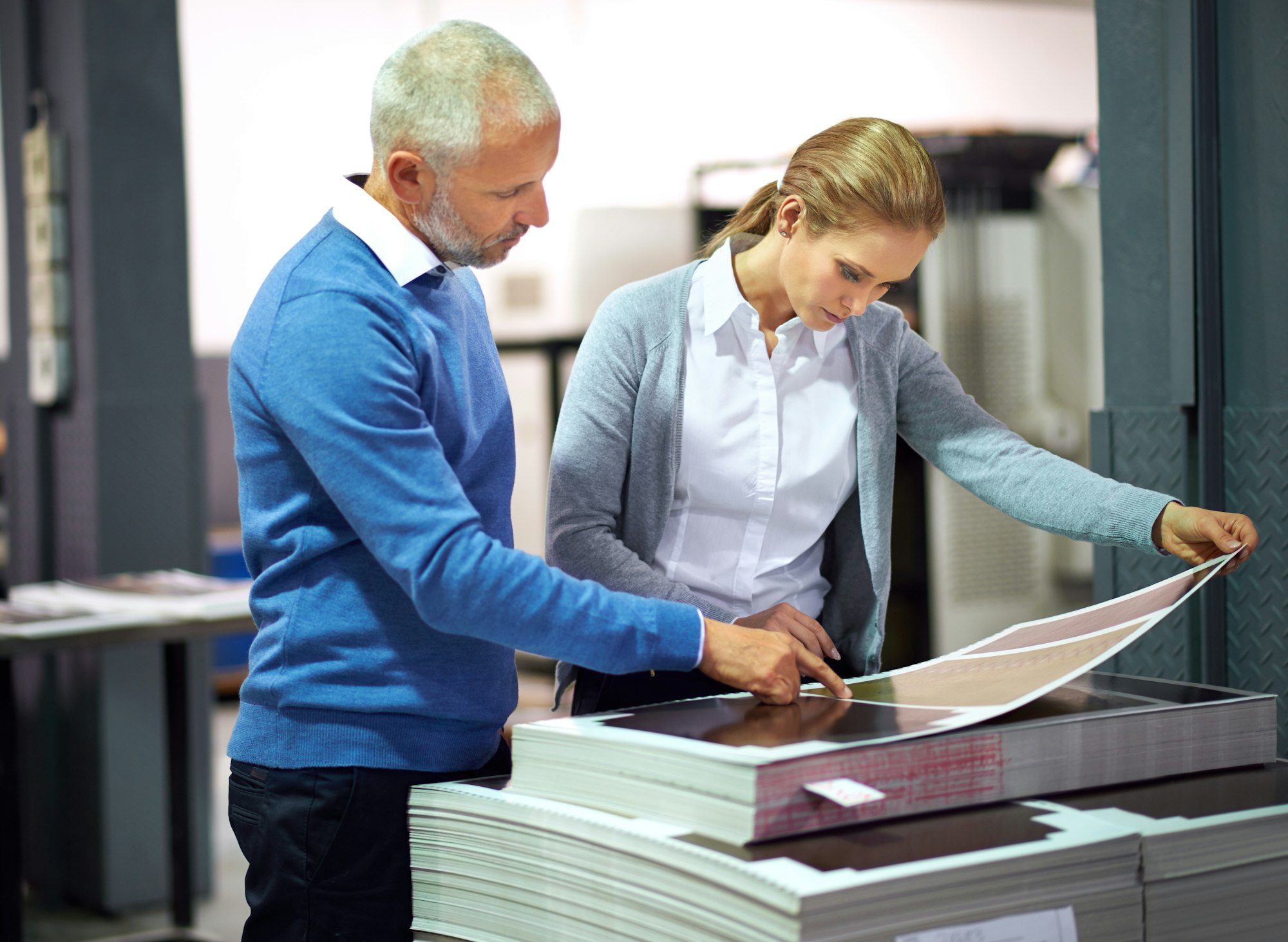 This is good work...Two publishers assessing the quality of printed work in a factory.
