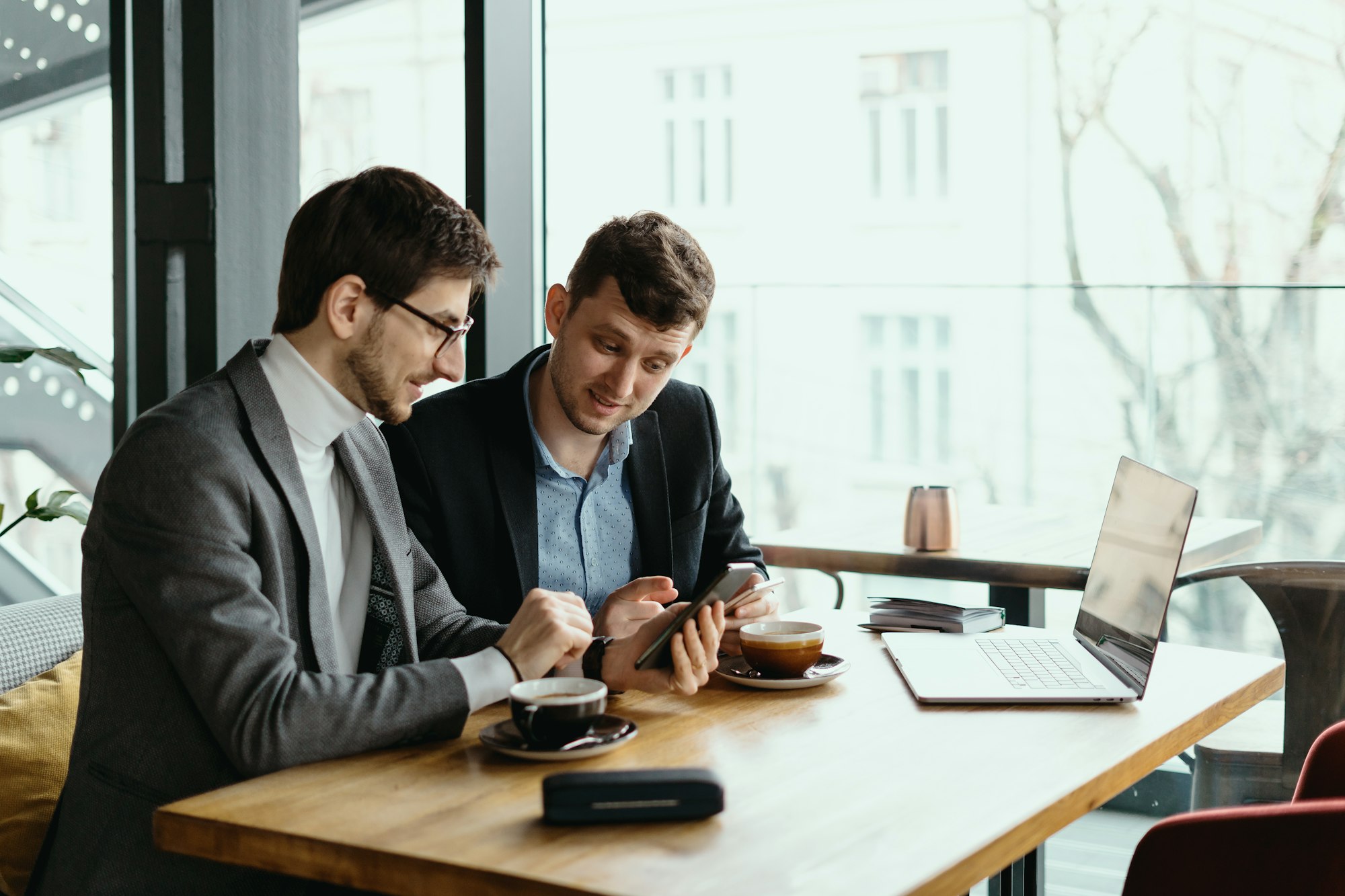 Two young businessman having a successful meeting at restaurant.